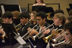 Students sitting holding trumpets