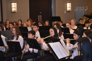 Students sitting and playing musical instruments